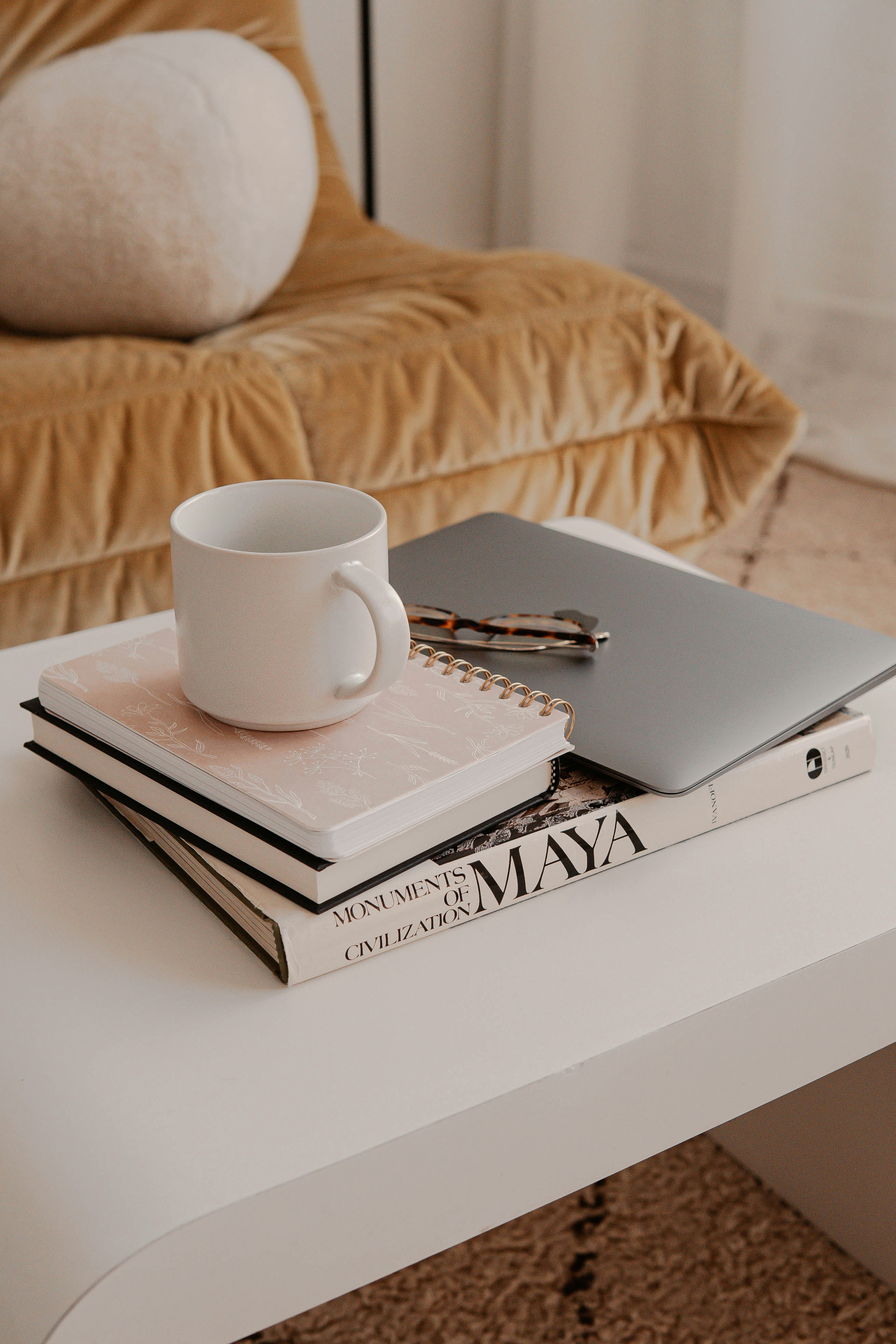 white ceramic mug on white book